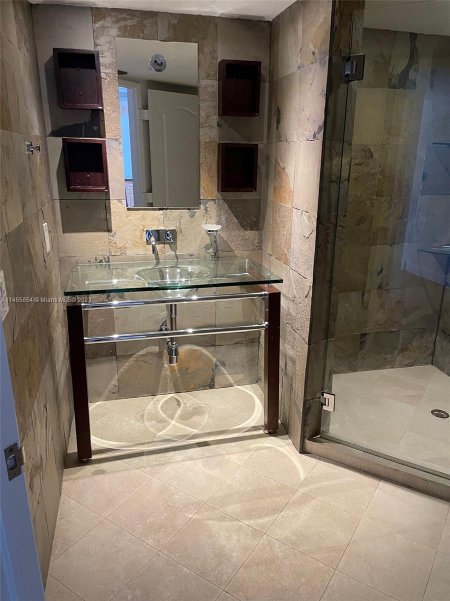 1900 Sunset Harbour Drive, Unit 1209 Miami Beach, FL 33139 - Photo 34 of 35 a bathroom with a granite countertop sink a mirror and shower