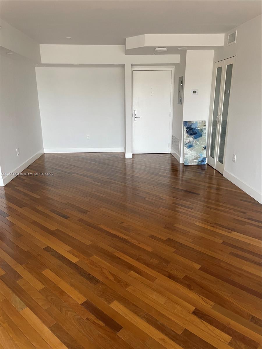 1900 Sunset Harbour Drive, Unit 1209 Miami Beach, FL 33139 - Photo 5 of 35 a view of empty room with wooden floor