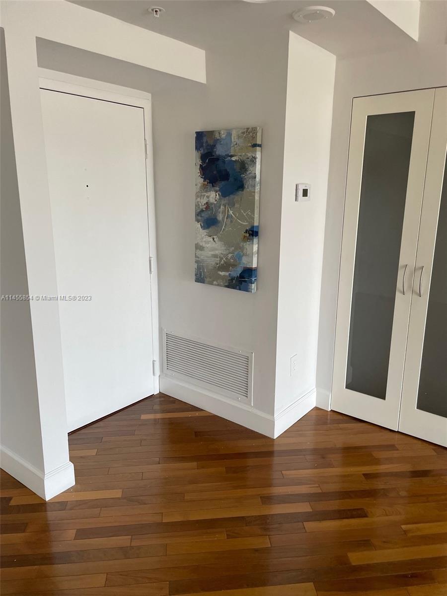 1900 Sunset Harbour Drive, Unit 1209 Miami Beach, FL 33139 - Photo 7 of 35 a view of a hallway with wooden floor
