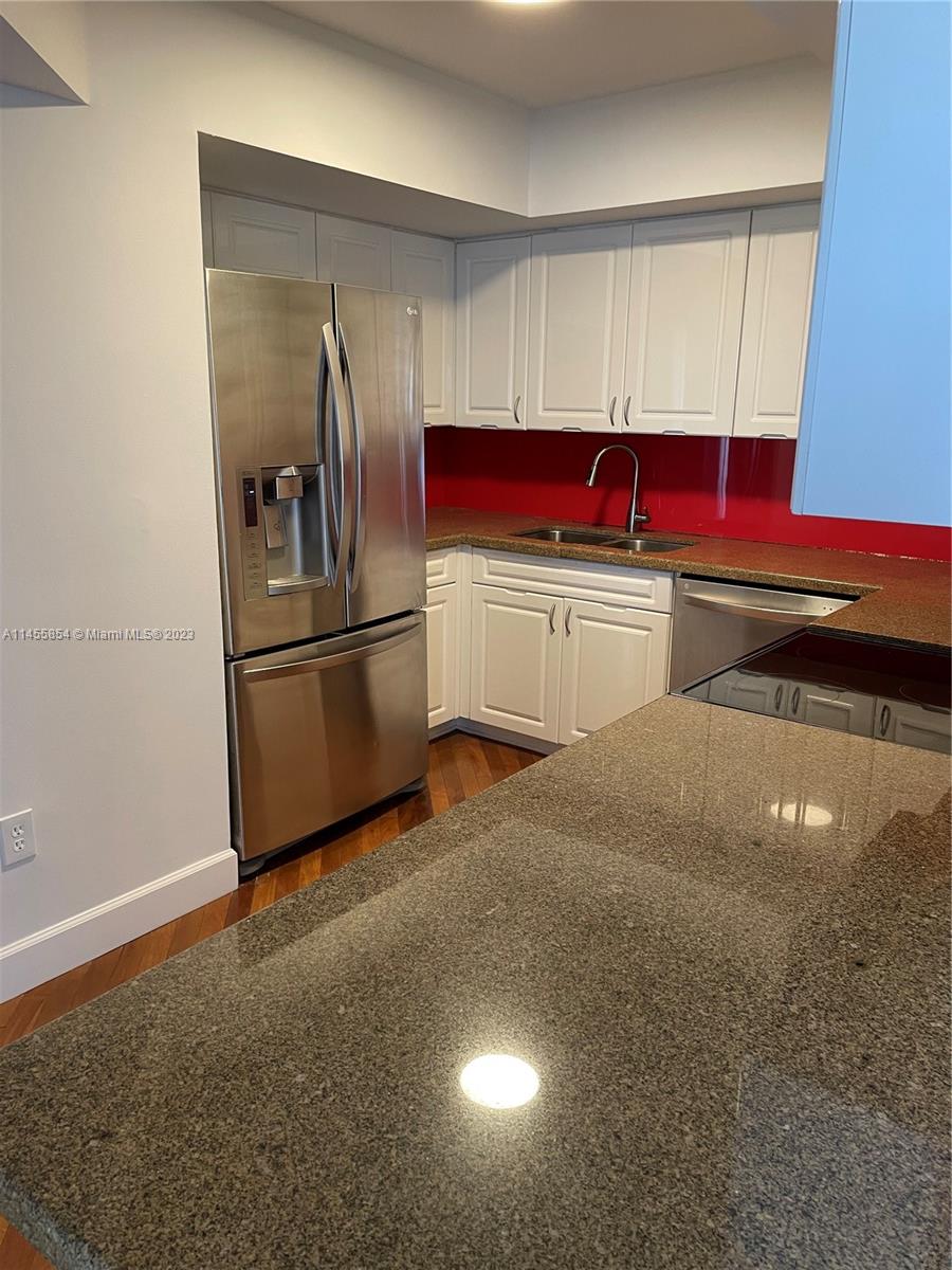 1900 Sunset Harbour Drive, Unit 1209 Miami Beach, FL 33139 - Photo 10 of 35 a kitchen with stainless steel appliances a refrigerator sink and cabinets