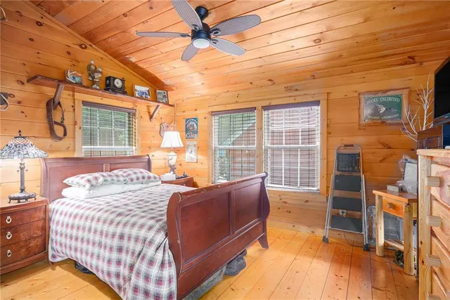a bed sitting in a bedroom next to a window