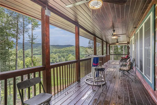 a view of a patio with table and chairs floor to ceiling window with wooden floor