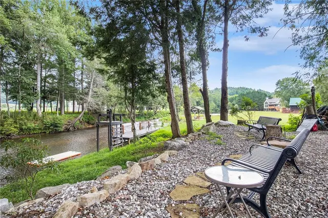 a view of a chair and table in the garden