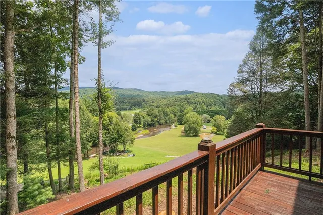 a view of a balcony with yard
