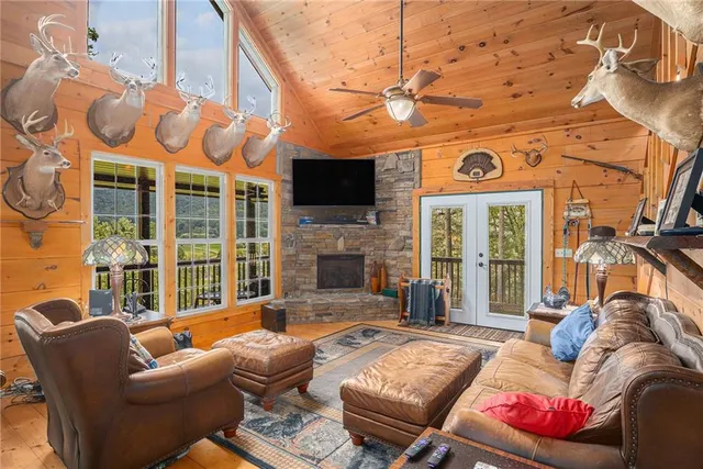 a living room with furniture a flat screen tv and a fireplace