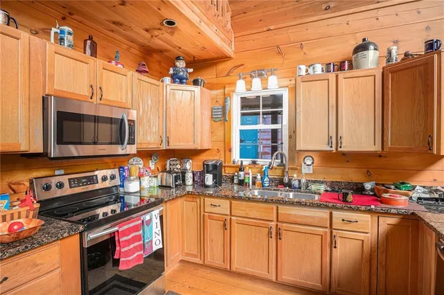 a kitchen that has a sink and a stove in it