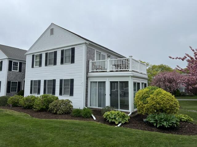 99 Depot Road, Unit 23 Chatham, MA 02633 - Photo 2 of 4 a front view of a house with a garden
