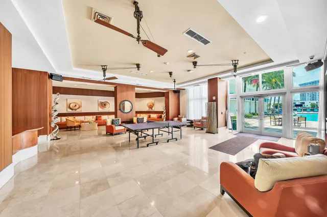 a view of a hallway with wooden floor and a bathroom