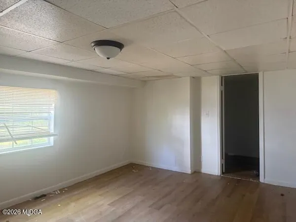 an empty room with a empty space and windows