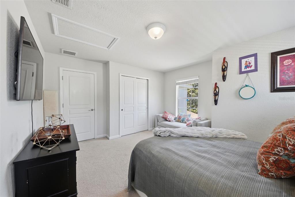 7519 Brofield Avenue Windermere, FL 34786 - Photo 28 of 49 a bedroom with a bed and wooden floor