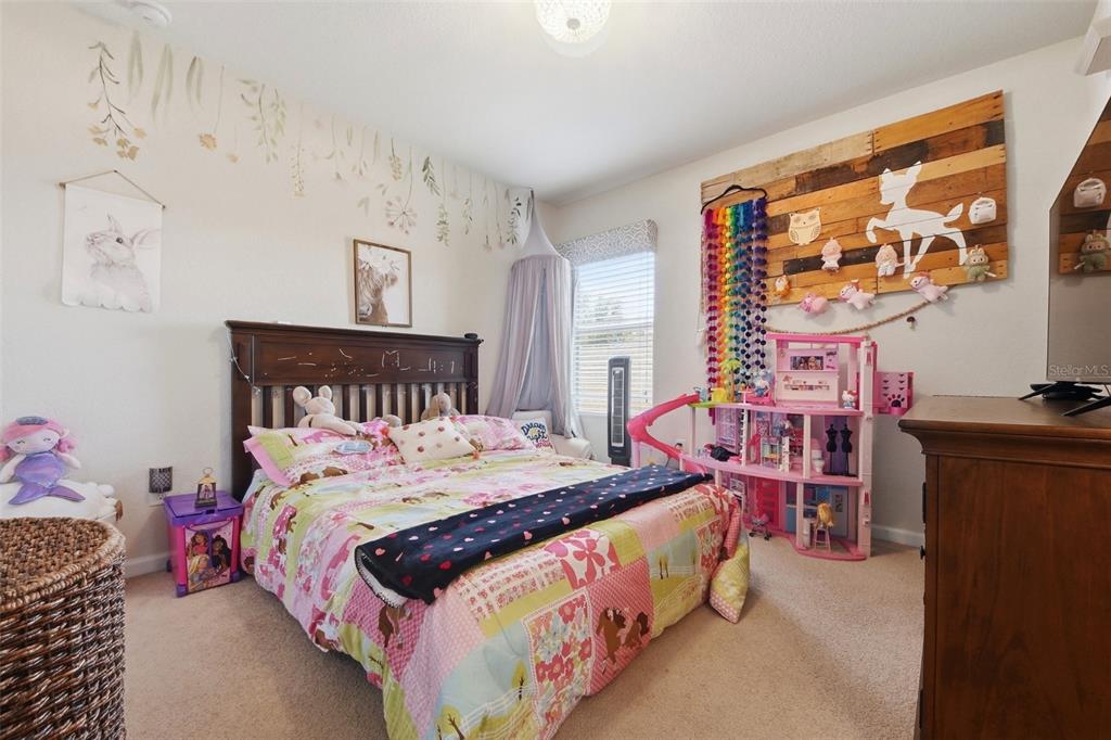 7519 Brofield Avenue Windermere, FL 34786 - Photo 30 of 49 a bedroom with a bed and a painting on the wall