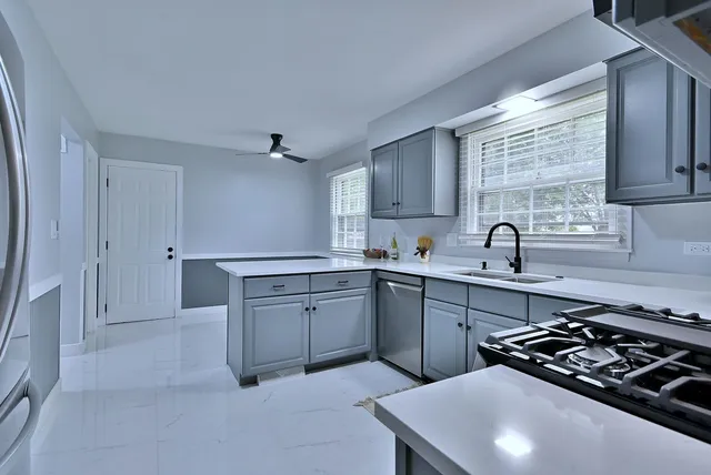 a kitchen that has a sink and a stove