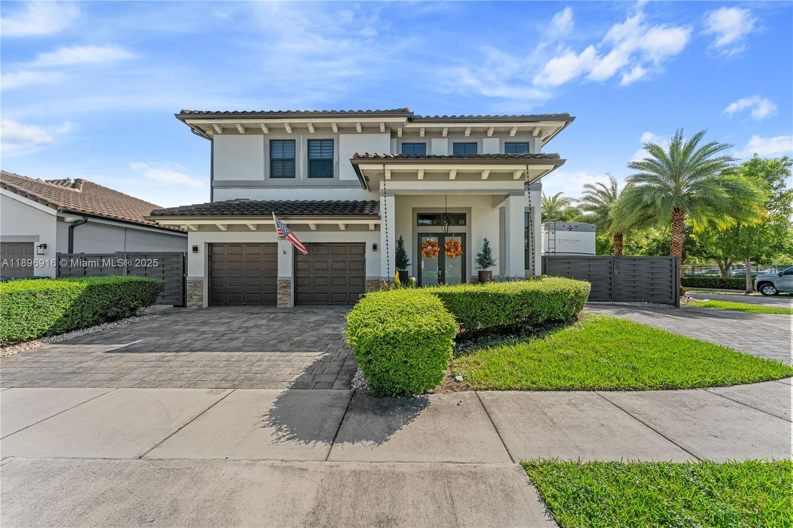 a view of a house with many windows and plants