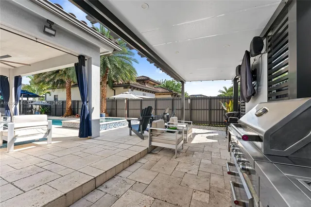 a view of a outdoor space with a table and chairs under an umbrella