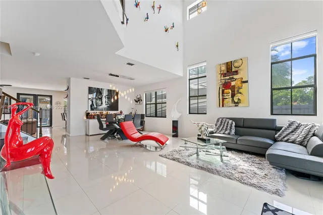 a living room with furniture kitchen view and a rug
