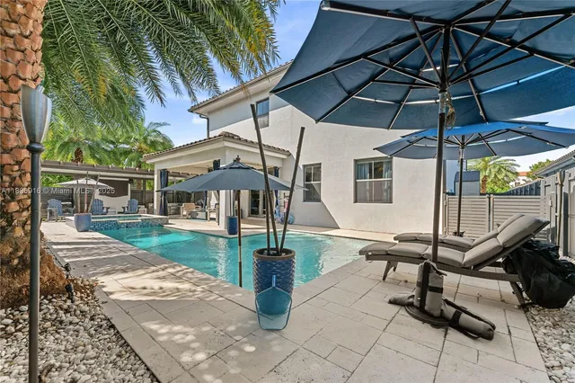 a view of a patio with dining table and chairs