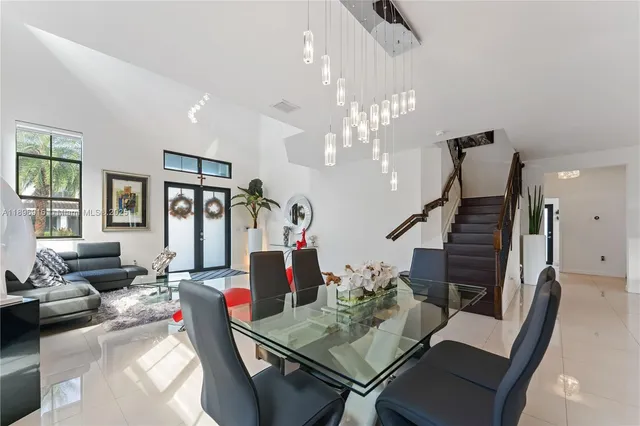 a kitchen with stainless steel appliances kitchen island granite countertop a refrigerator and cabinets