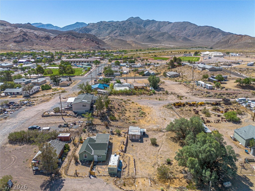 405 Main Street Beatty, NV 89003 - Photo 27 of 28 An aerial perspective reveals a desert community nestled at the base of majestic mountains, offering ample space for future development.