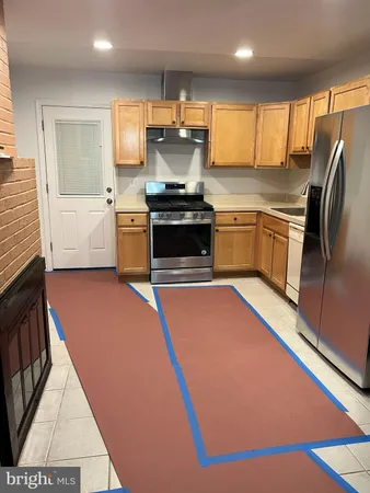 a kitchen with a refrigerator and a sink