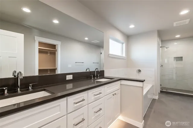 a large white kitchen with a sink and cabinets
