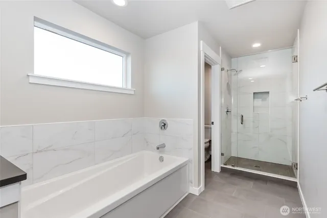 a bathroom with a bathtub and a shower