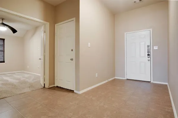 a view of an empty room and bathroom