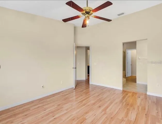 a view of an empty room with wooden floor