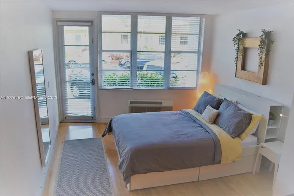 a bedroom with a bed and a large window