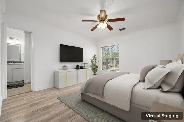 a bedroom with a bed and a flat screen tv