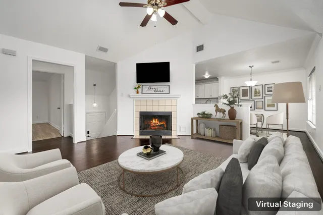 a living room with furniture a fireplace and a flat screen tv