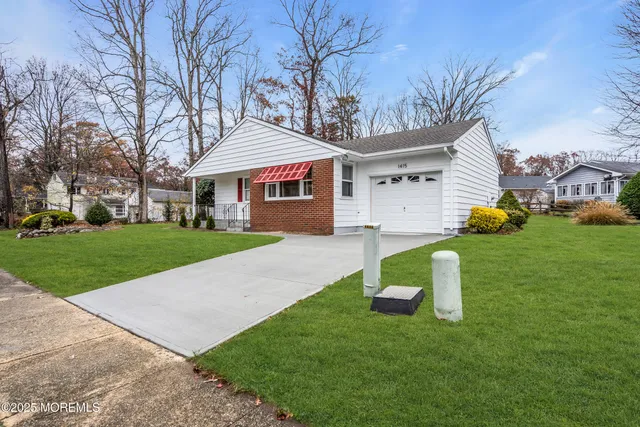 a front view of house with yard and green space