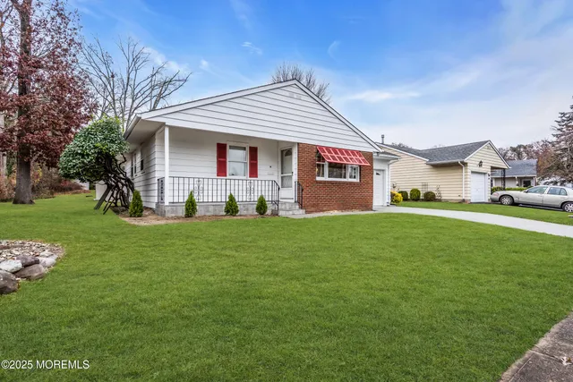 a bedroom with bed and wooden floor