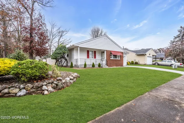 a bedroom with a bed and a large mirror on the dresser