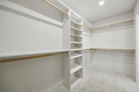 a view of walk in closet with empty racks