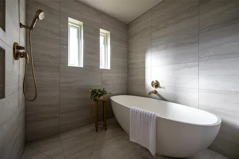 a bathroom with a bathtub and shower