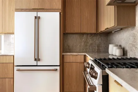 a kitchen with a refrigerator and a stove
