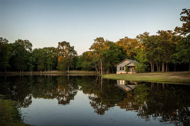 a view of a lake with a house in the background