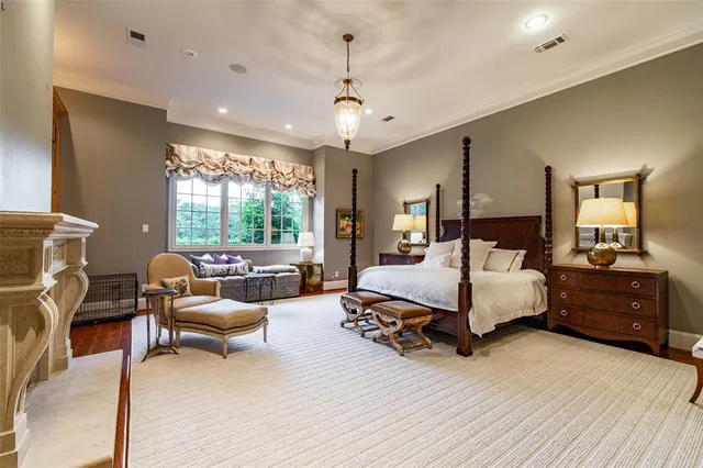 a bedroom with furniture and a large window