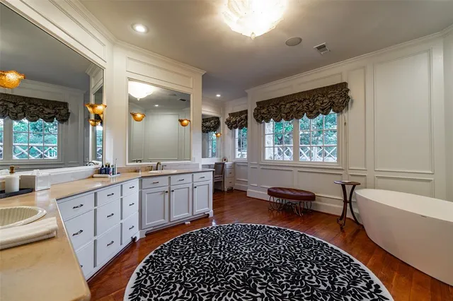 a large white kitchen with a large window