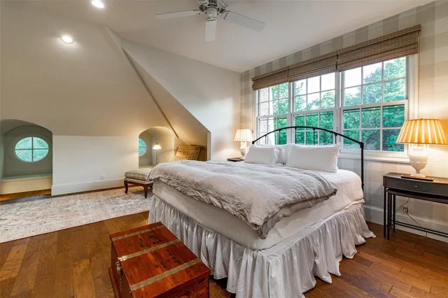 a spacious bedroom with a bed and a chandelier