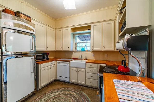 a kitchen with a sink cabinets and appliances