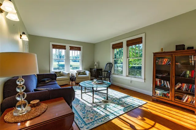 a living room with furniture and a book shelf