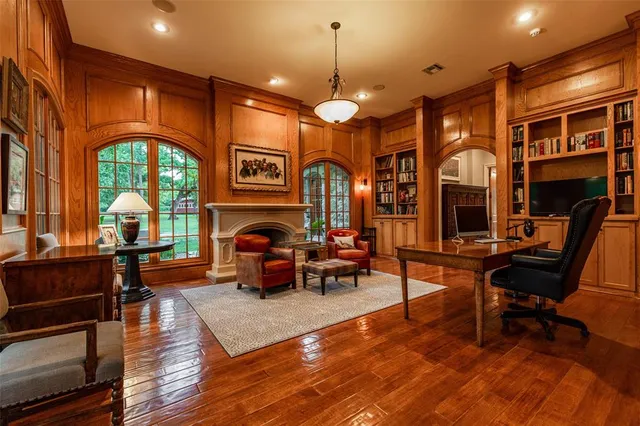 a living room with furniture a fireplace and a chandelier