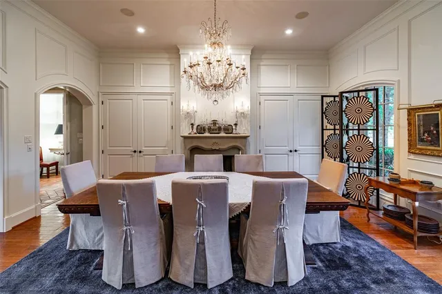 a view of a dining room with furniture a chandelier and wooden floor