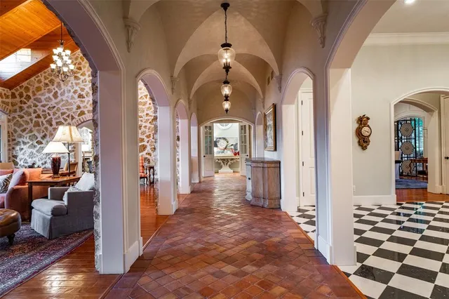 a view of a hallway with windows and wooden floor