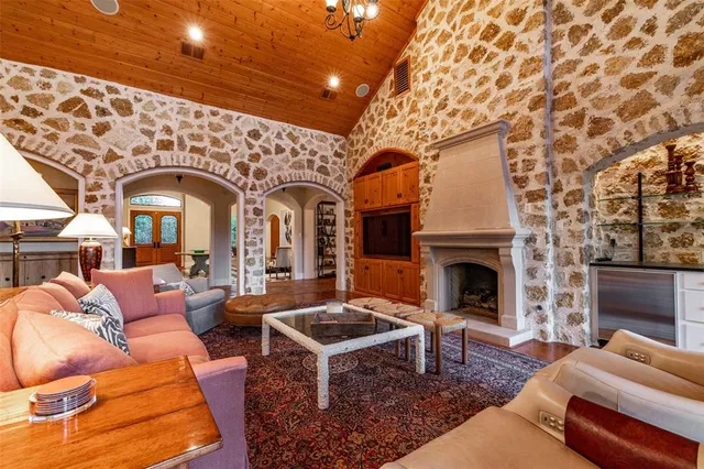 a living room with furniture a fireplace and a flat screen tv