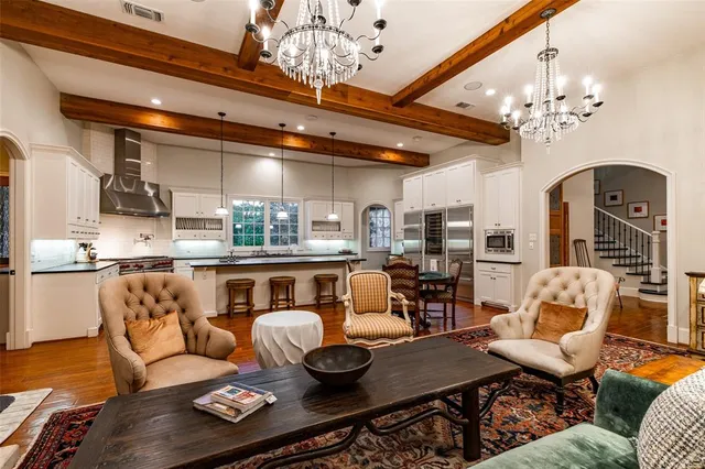 a living room with furniture and chandelier