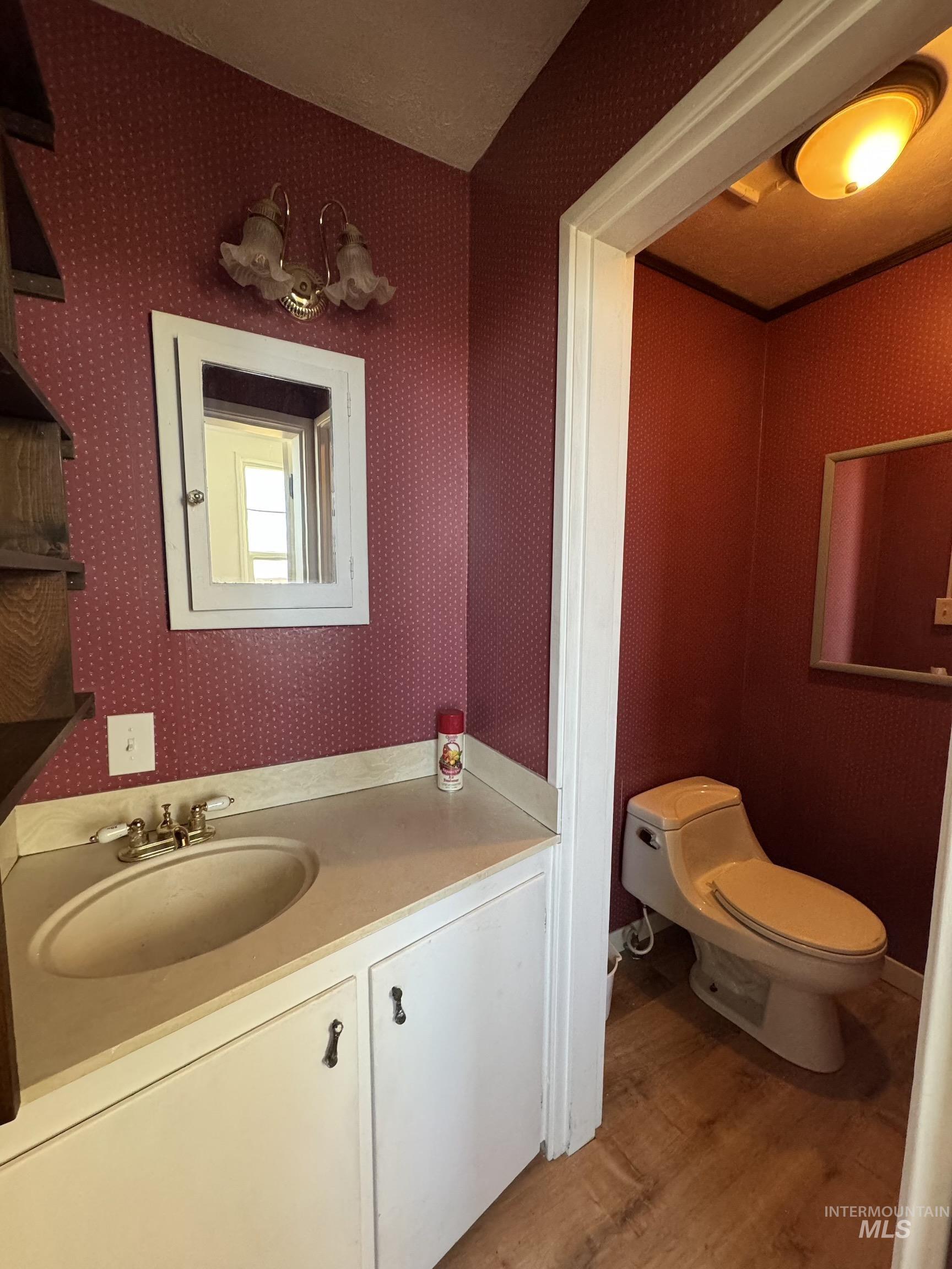 729 Morgan Avenue Ontario, OR 97914 - Photo 20 of 49 Half bathroom with wood finished floors and vanity