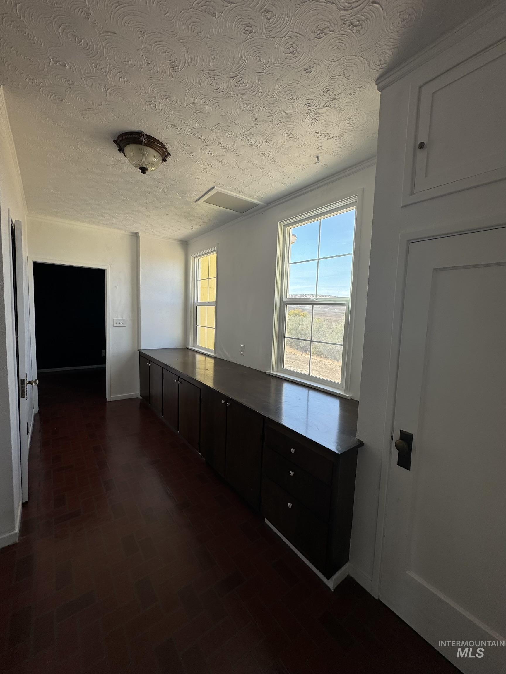 729 Morgan Avenue Ontario, OR 97914 - Photo 29 of 49 Hallway featuring a textured ceiling and brick patterned flooring