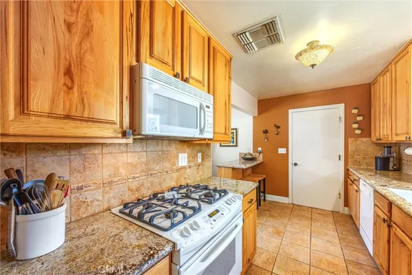 a kitchen with a sink and a stove top oven